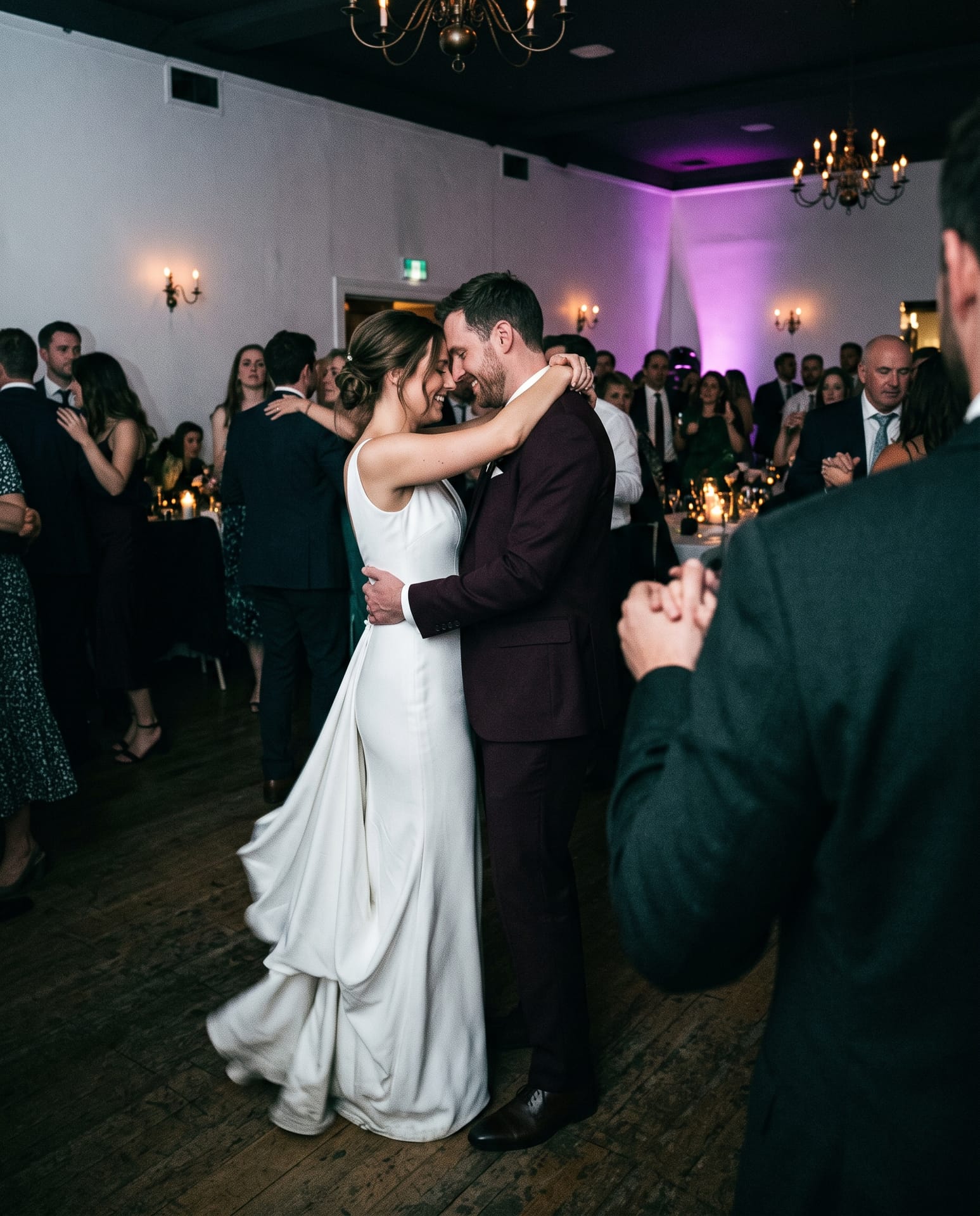 A couple dancing, photographed from among the guests.