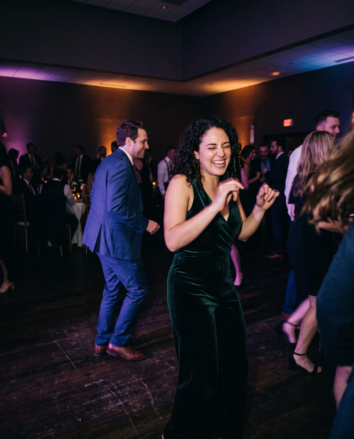 Guests with phones around the couple, late at night.