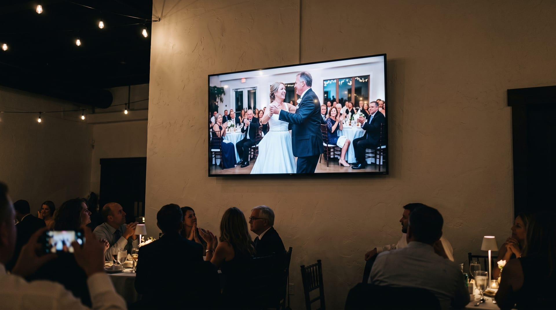 The album projected on screens above the dinner tables.