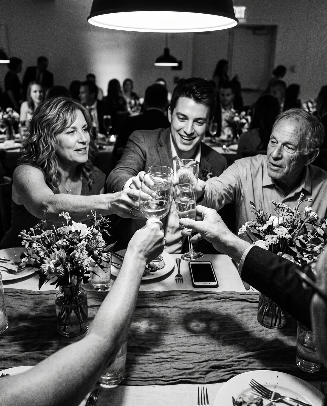 The couple raising a toast among sparklers.